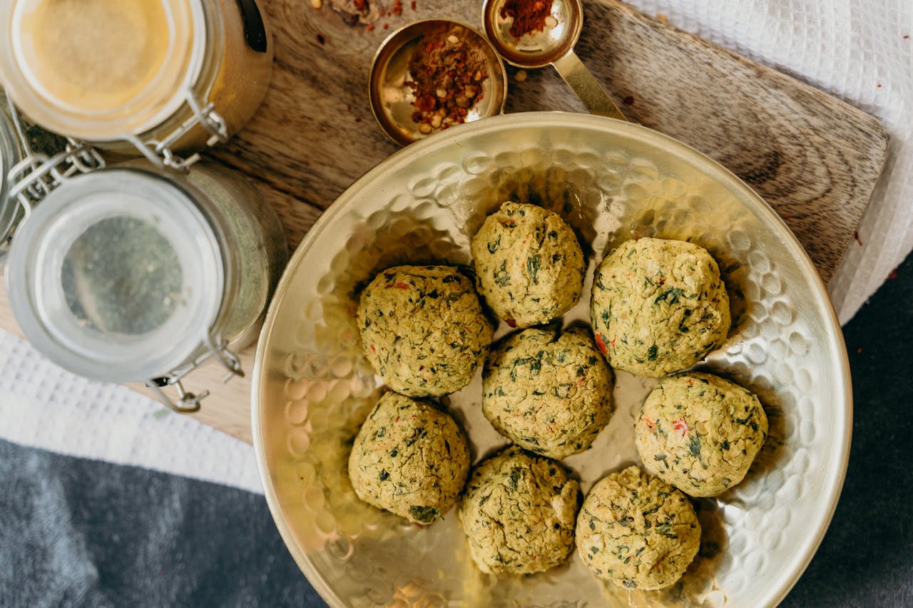 Top view of freshly made vegan falafel on a bronze plate, showcasing a healthy and organic meal option.